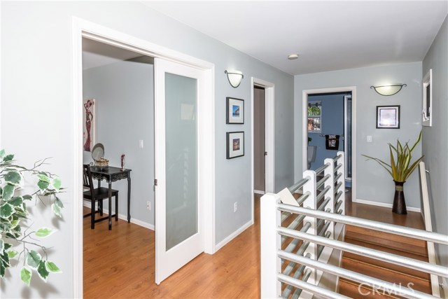 Top of stairs with bedroom directly at top of stairs, back bedroom next and then huge middle bedroom.  Hall is generous enough to have small pieces of furniture, bookshelves, plants, etc.