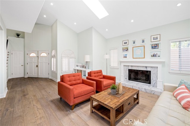 Front living room showcased by marble stone fireplace