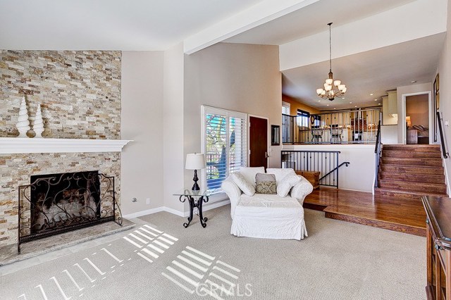 Custom stone and quartz fireplace in living room looking up toward the dining area and kitchen Custom stone and quartz fireplace in living room looking up toward the dining area and kitchen