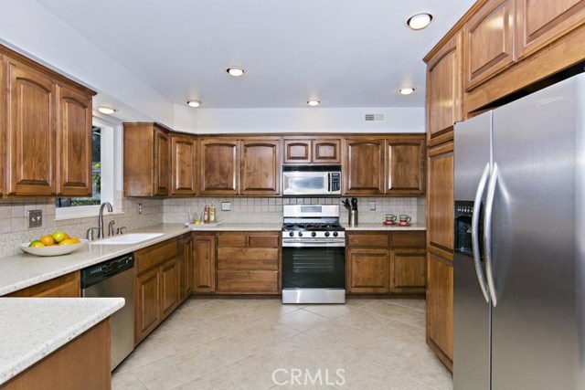 Kitchen with stainless steel appliances, including a NEW STOVE