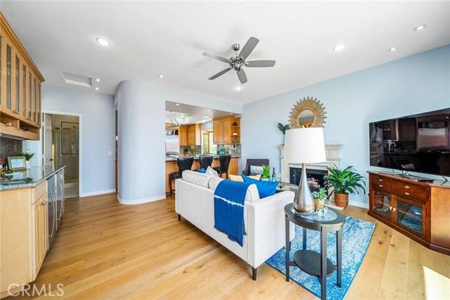View of family room from landing at the top of the stairs.  The kitchen in the background.  The wet bar is to the left.