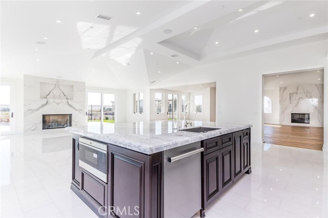 Kitchen opens to living room and family room with a ton of natural lighting