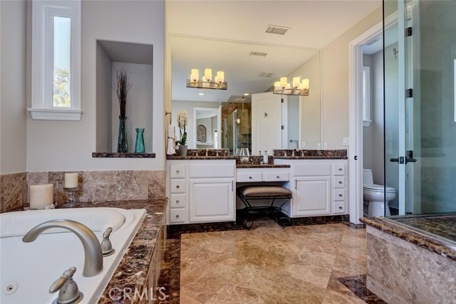 The opulent Master Bathroom is fit with an enviable soaking tub, perfect for melting the day away, plus double sinks and vanity.