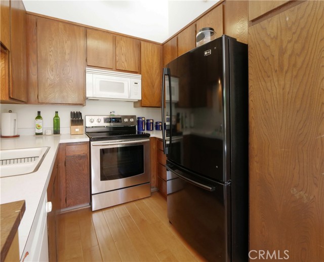 Stainless steel range, microwave, refrigerator-freezer, dishwasher.