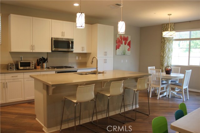 Spacious kitchen with stainless steel appliances and breakfast area view of the backyard.