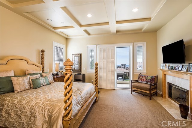 Master bedroom with fireplace and ocean view.  West facing balcony