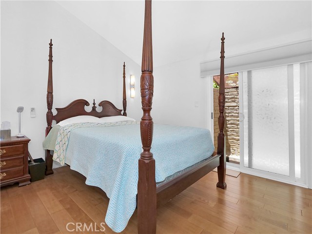 Master bedroom with high ceilings opens to private patio.
