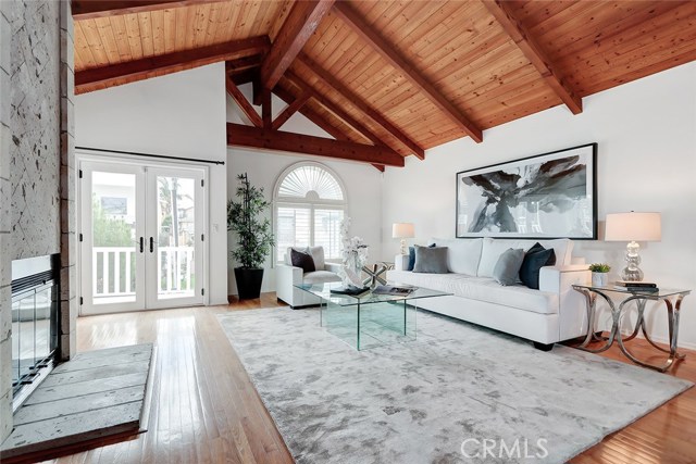 wood beam vaulted ceiling and outdoor balcony offers colorful sunset views and ocean breezes
