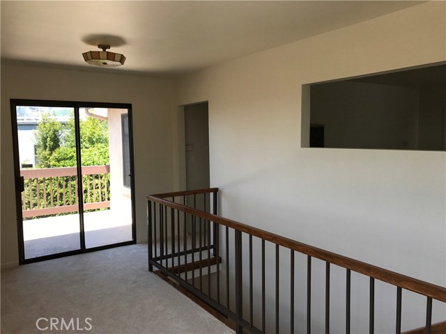 Gallery at top of stairs with new carpet, sliders to deck