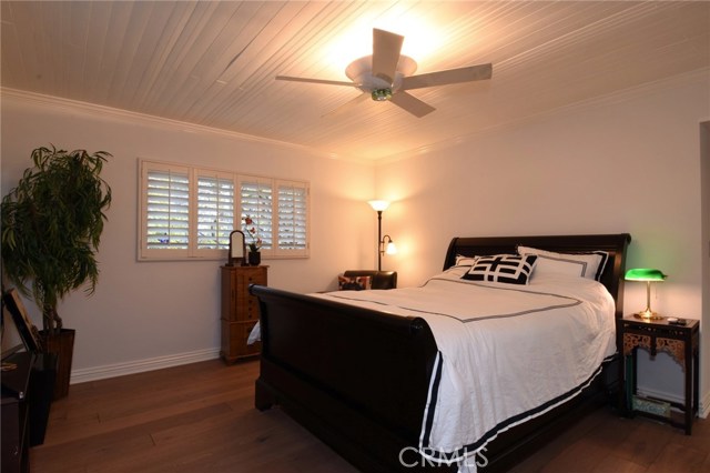 Terrific master bedroom has beautiful wood wainscot ceilings and pretty ceiling fan.