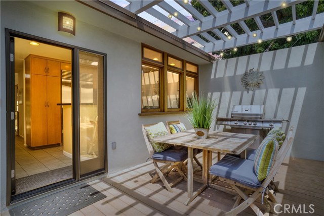 Pergola covered outdoor dining area off kitchen in front courtyard area.