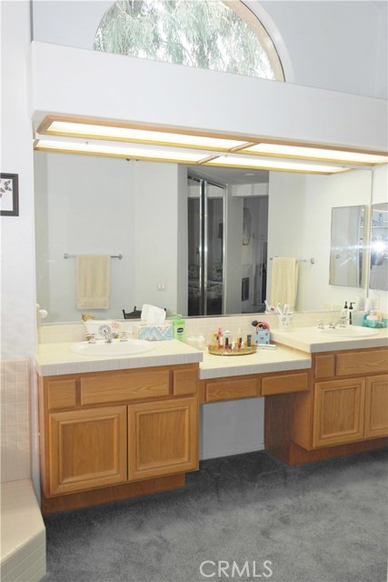 Master Bathroom With Lots Of Natural Light Has Dual Sinks And Vanity.