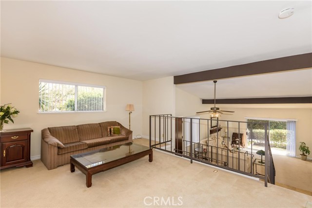 Looking over from living area to family room and adjacent patio.