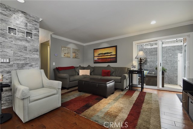 Recent remodel yields open living room with patio access, plus bonus accent walls for texture and depth.