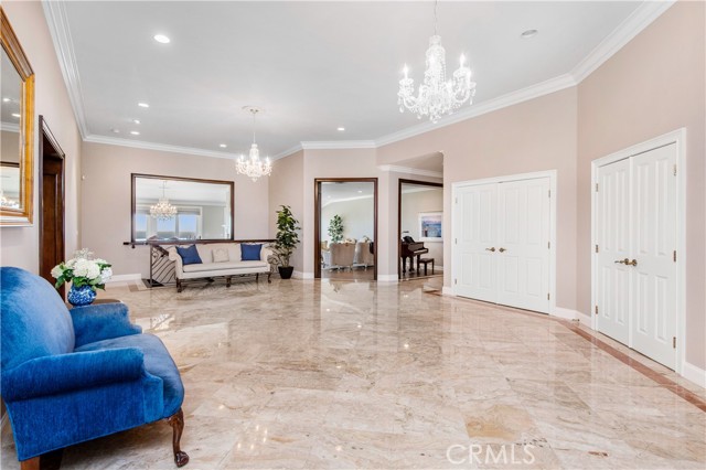 Grand marble foyer with view to the ocean, dining room, and formal living room