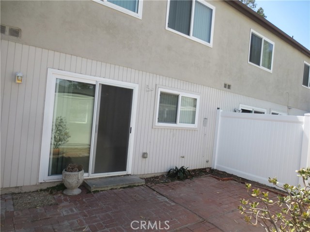 Large patio has nice tomato planting area next to garage
