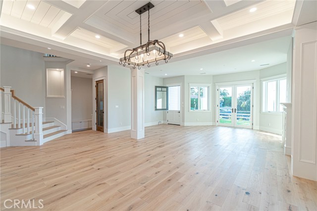 View from dining area towards the front door and french doors that open to wrap-around porch.