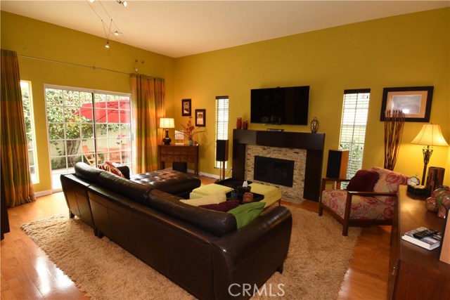 Family room has beautiful hard wood flooring, stunning fireplace, and slider to the rear yard