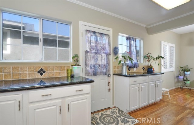 Kitchen has loads of granite countertops, drawers and cabinets for the cook  and lots of light