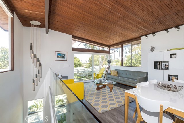 Dramatic and light-filled entry stairs with original light fixture