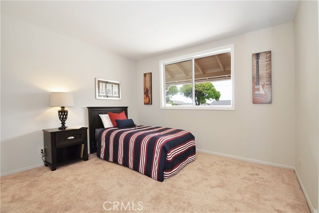 Bedroom 2 has a City Light View, new Mirror Closet Doors, neutral carpeting and paint.