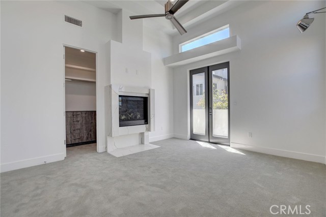 2nd Level . . . Master Bedroom with Fireplace, walk in closet with custom cabinetry, and access to private balcony