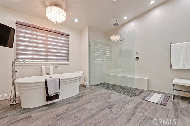 The Master Bathroom is your very own spa, featuring a courteous coming together of masculine and feminine elements, suited with a sleek, open glass enclosure for the waterfall shower, celestial light fixtures, and beaming skylights.