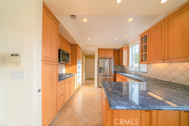 View from dining area to garage door. Laundry and powder rooms located just beyond the kitchen.