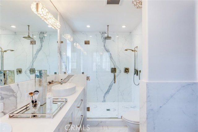 On the other end of the double sinks an vanity area is the large walk in shower with multiple shower heads for your to choose from