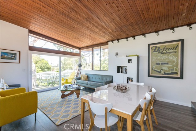 Living Room with gorgeous wood floors, ceilings, walls of glass and front sitting deck with Ipe wood and custom railing.