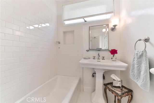 Pedestal Sink with Subway Tile Shower/Tub