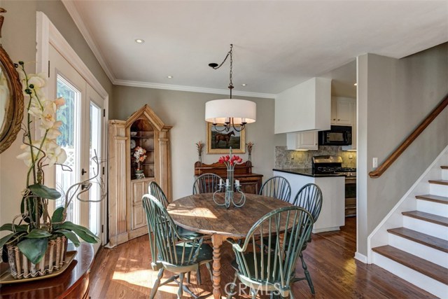 Dining room with smooth ceilings, recessed lights and hardwood floor.