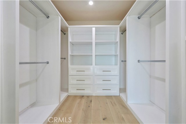 The Walk-in Closet has ample Hanger Space and a built in 6-Drawer Vanity Cabinet