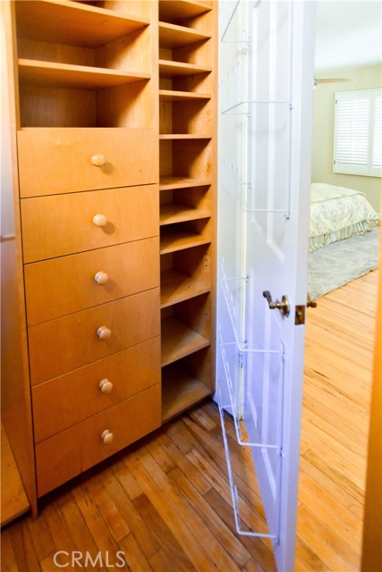 Walk in closet with plenty of drawers and shoe space.