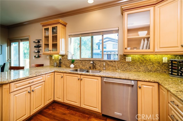 Beautiful kitchen featuring refined cabinetry, gorgeous granite counter tops, stainless steel appliances, ample storage and counter space, and open to the living room.