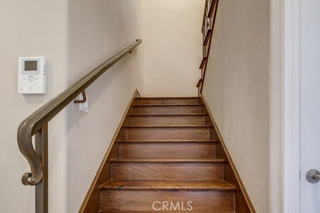 Wrought iron railings and wood floors guide your path to the open concept floor plan.