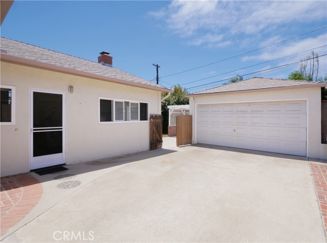 Side door to home and gate leading to backyard.  Detached garage.