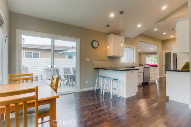 Family room, eating area open to kitchen.  Look at those gleaming hard wood floors and high pitched ceilings.