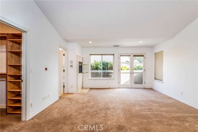 Large en-suite master bedroom with French doors leading to balcony