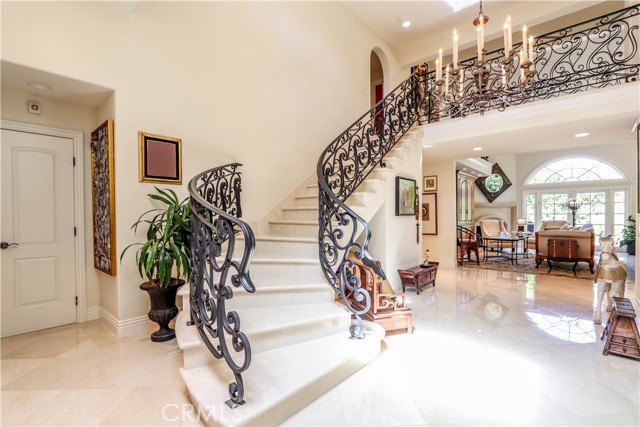 Stunning Crema Marfil marble floors/staircase continuing t/o upstairs.
