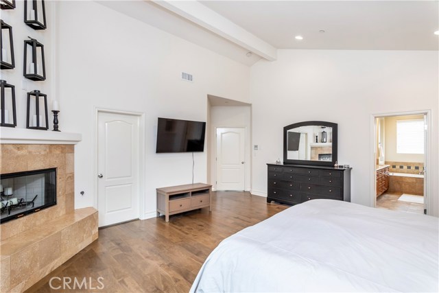 Master Bedroom with vaulted ceiling and fireplace