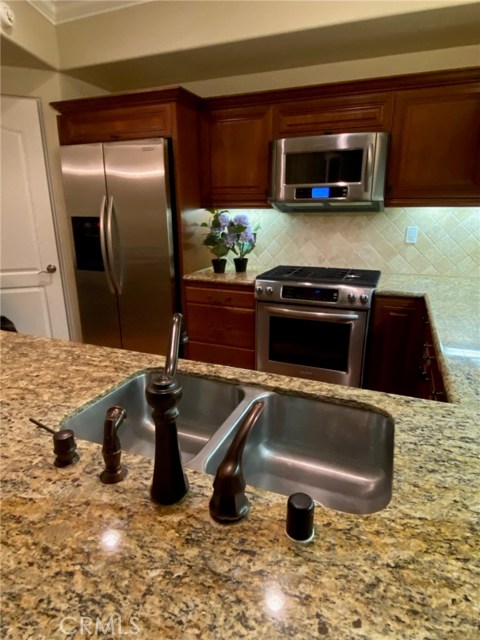 Dual Stainless Sink with Bronze colored Fixtures.