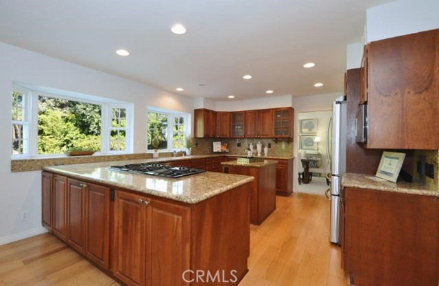 Open Kitchen has Bay Windows with Views of the Beautiful Backyard.