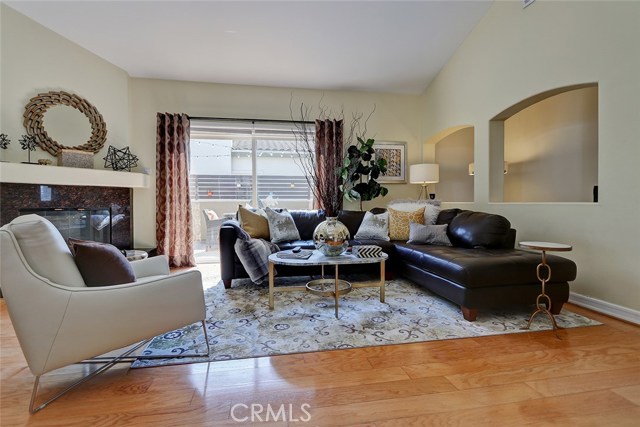 Spacious living room with hardwood floors and vaulted ceilings.