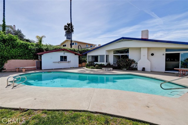 FROM THE BACKYARD AT THE POOL, POOL HOUSE, AND SINGLE STORY HOME.