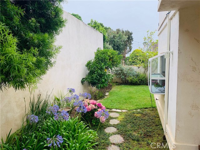 The garden in full bloom in the Springtime! Other flowers and vegetation in bloom year around. This is a photo from the middle of the backyard where you can admire the beauty from the garden window.