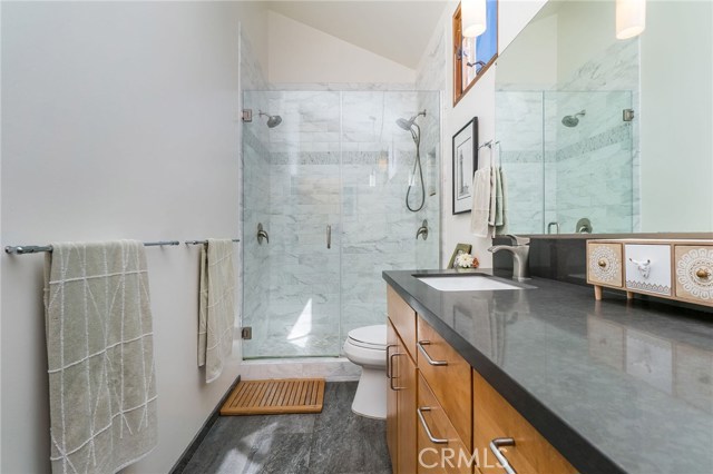 Master bathroom with double vanity and marble tile.