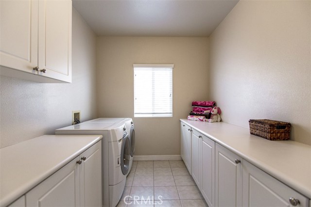 Large separate laundry room with plenty of counter top space for folding laundry