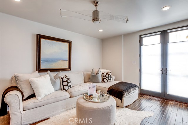 On the lower level spanning the west side of the home is the guest suite which includes this family room, a bedroom and ed-suite bath. The suite has private access from the street through these french doors.