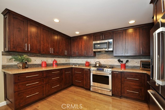 Beautifully remodeled kitchen with stainless steel appliances and quartz countertops.